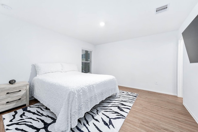 bedroom with hardwood / wood-style floors