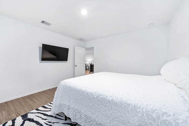 bedroom with hardwood / wood-style flooring