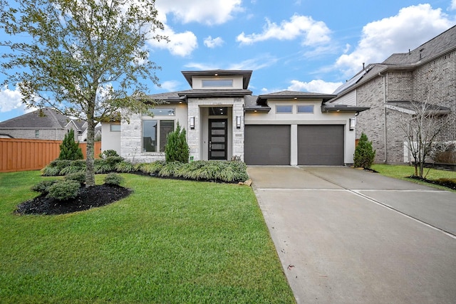 prairie-style home with a garage and a front yard