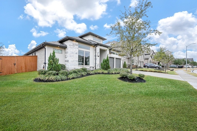 view of front of property featuring a garage and a front yard