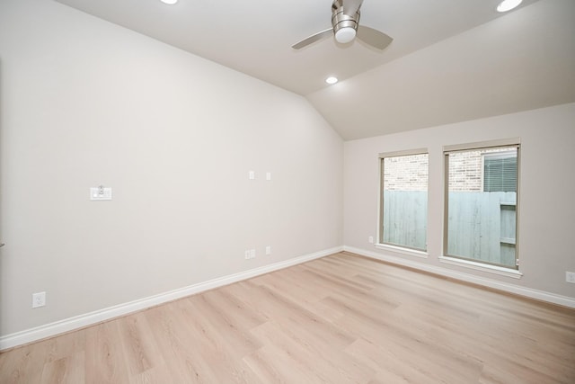 unfurnished room with lofted ceiling, ceiling fan, and light hardwood / wood-style flooring