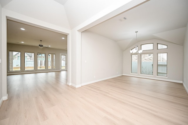 unfurnished living room featuring lofted ceiling, ceiling fan with notable chandelier, and light hardwood / wood-style flooring