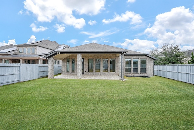 back of house with a yard and a patio area