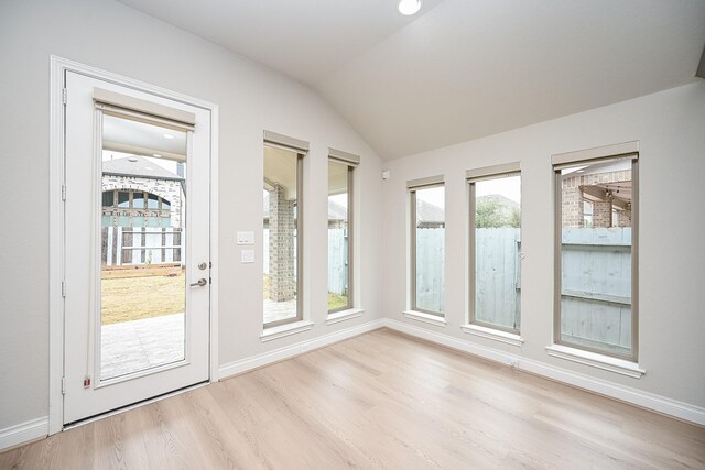 interior space with a healthy amount of sunlight and vaulted ceiling