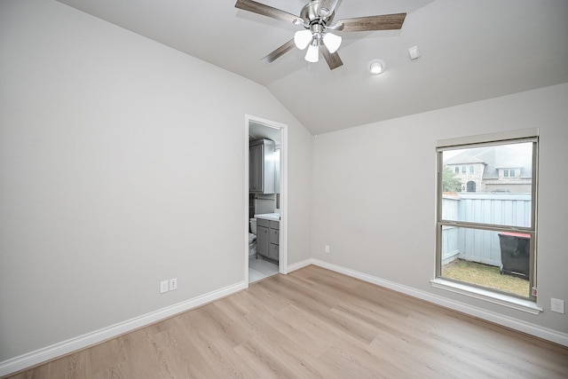 unfurnished bedroom with ceiling fan, ensuite bathroom, light hardwood / wood-style floors, and multiple windows