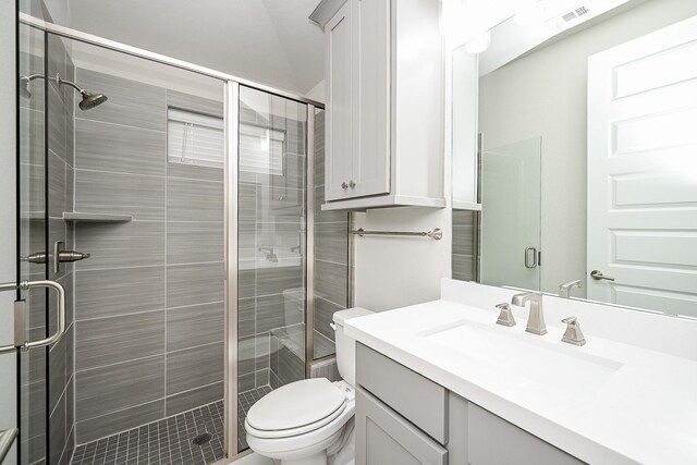 bathroom with vanity, toilet, and an enclosed shower