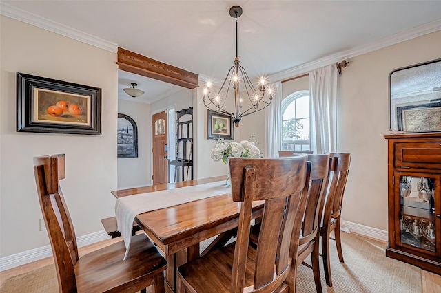 dining space with crown molding and a chandelier