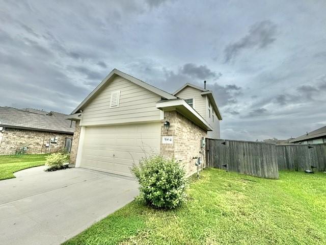 view of property exterior featuring a yard and a garage