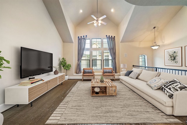 living room featuring ceiling fan, dark hardwood / wood-style floors, and high vaulted ceiling