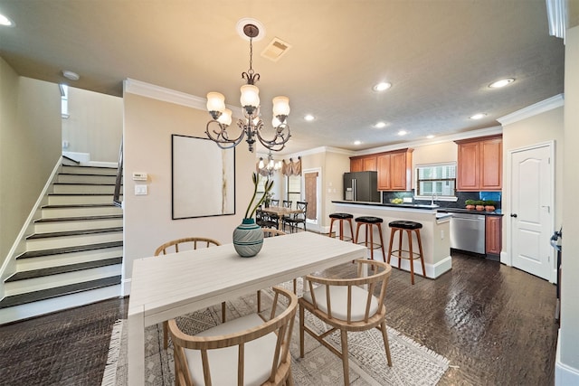 dining room featuring an inviting chandelier, dark hardwood / wood-style floors, and crown molding