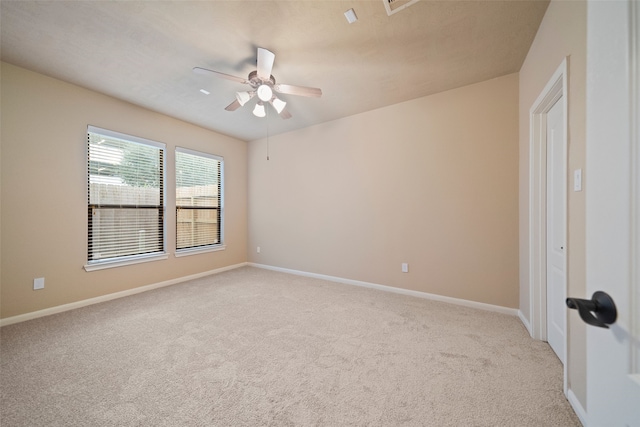 carpeted empty room featuring ceiling fan