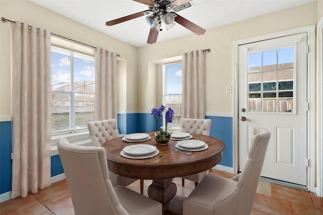 tiled dining area featuring ceiling fan