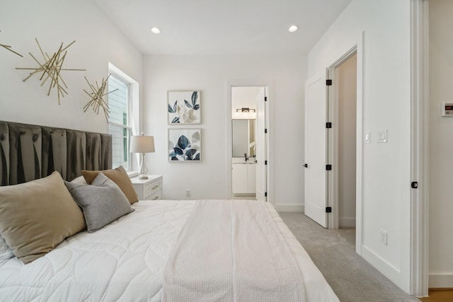 carpeted bedroom featuring ensuite bath