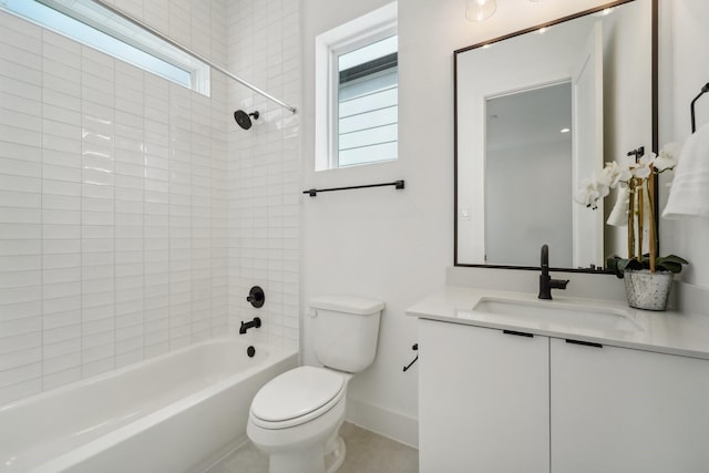 full bathroom featuring vanity, tiled shower / bath combo, and toilet