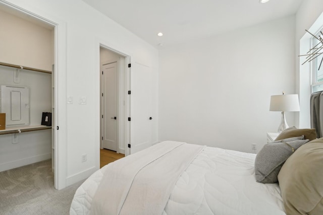 bedroom with light colored carpet and electric panel