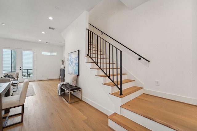 stairs featuring hardwood / wood-style floors