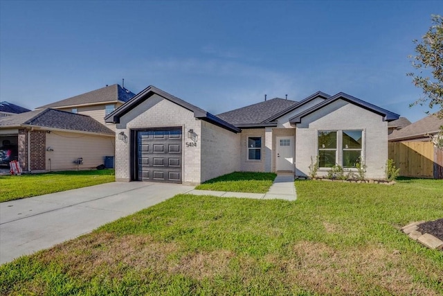 ranch-style home with a garage and a front yard