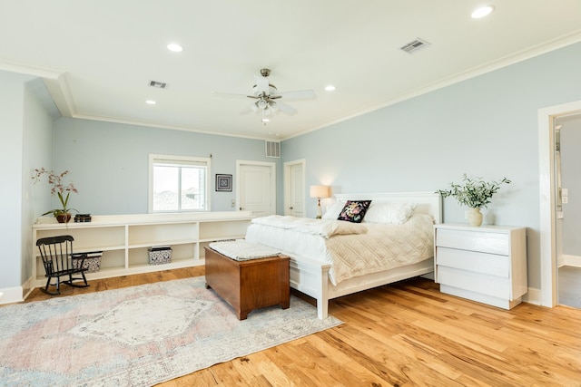 bedroom featuring crown molding and light wood-type flooring