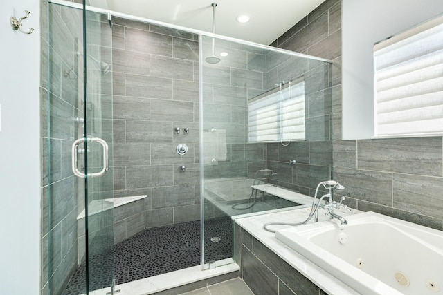 bathroom featuring separate shower and tub