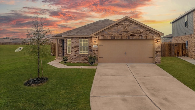 view of front of home with a garage and a yard