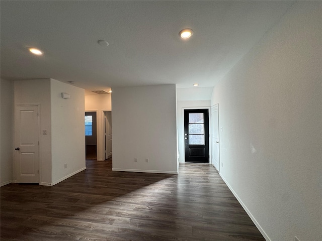 empty room featuring dark wood-type flooring