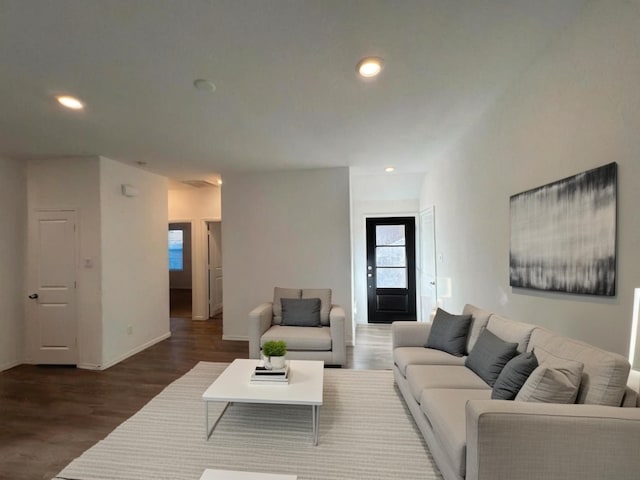 living room featuring baseboards, dark wood finished floors, and recessed lighting