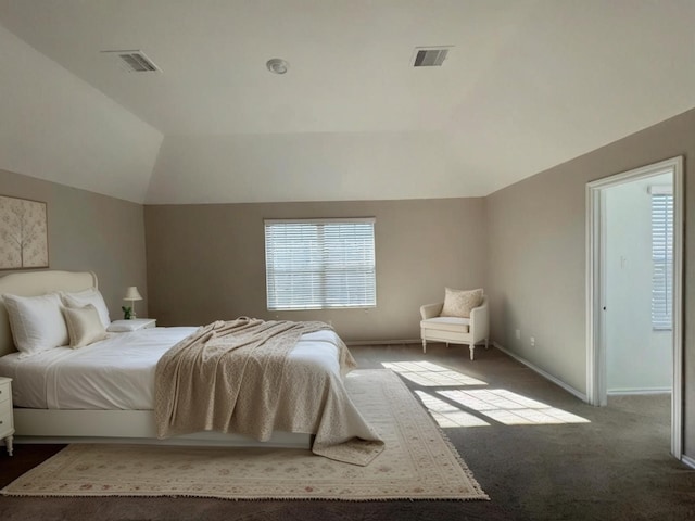 carpeted bedroom with baseboards, visible vents, and vaulted ceiling