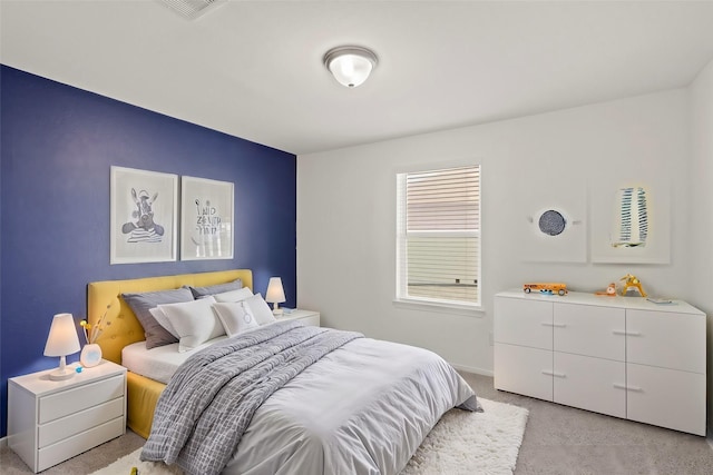 bedroom featuring light carpet