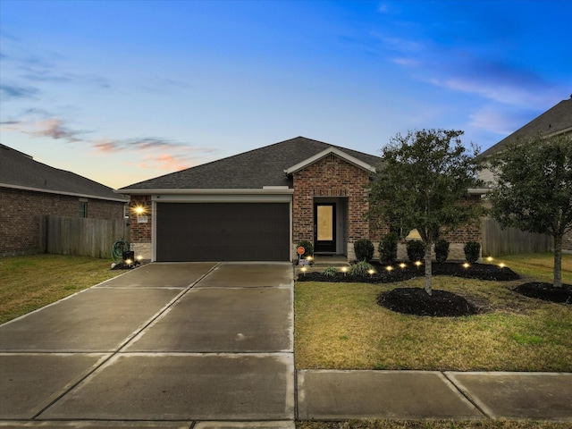 single story home with a yard and a garage