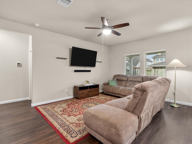 living room featuring ceiling fan and dark hardwood / wood-style flooring