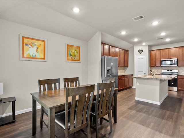 dining area with sink and dark hardwood / wood-style flooring