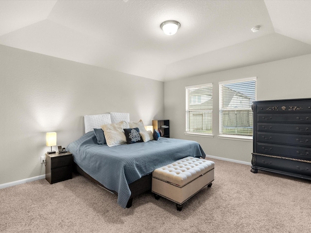 carpeted bedroom with lofted ceiling