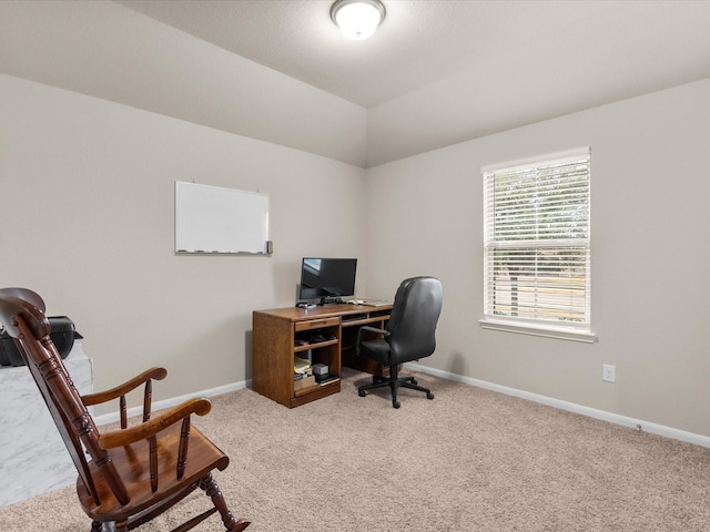 office space with vaulted ceiling and carpet flooring