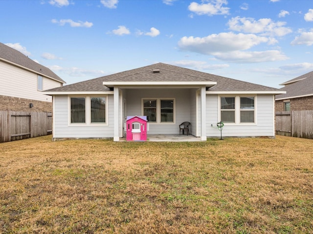 back of house featuring a patio area and a lawn