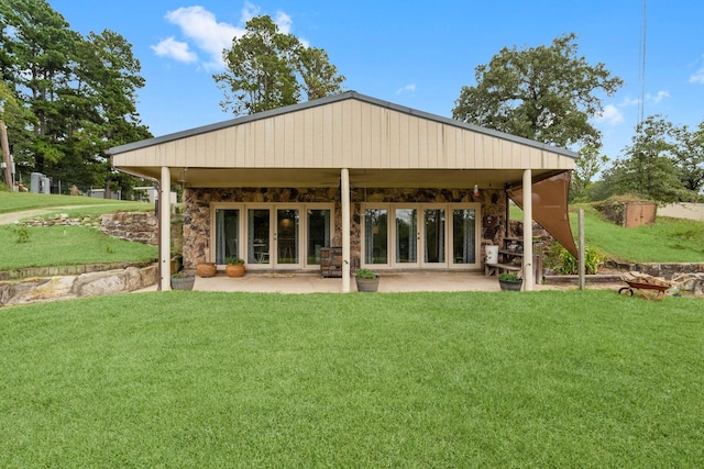 back of property featuring a patio and a lawn