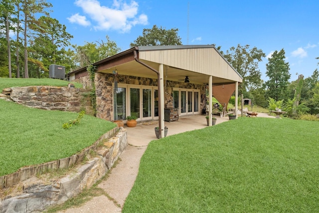 back of property featuring french doors, a patio, ceiling fan, and a lawn