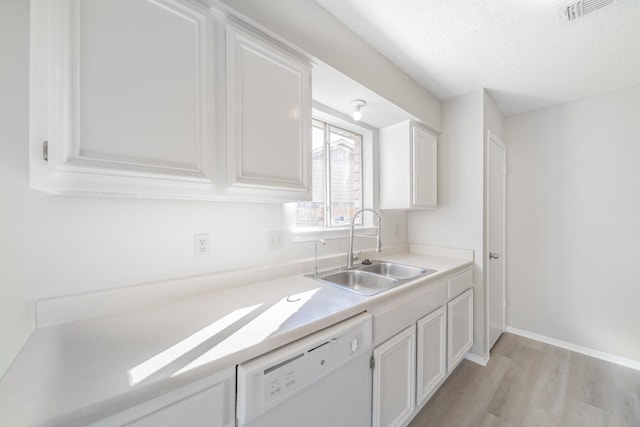 kitchen featuring sink, light hardwood / wood-style flooring, dishwasher, a textured ceiling, and white cabinets