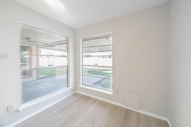 spare room featuring light wood-type flooring