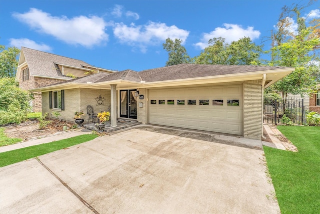 view of front of property with a garage and a front yard