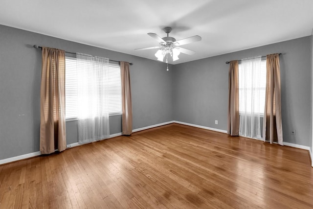 unfurnished room featuring ceiling fan and hardwood / wood-style floors