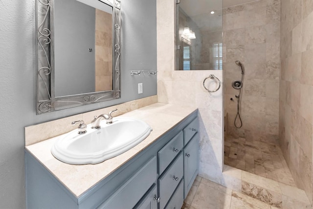 bathroom featuring vanity and a tile shower