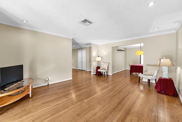 living area featuring crown molding, a textured ceiling, and light wood-type flooring