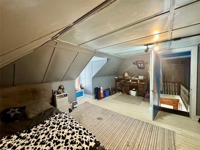 bedroom with lofted ceiling and hardwood / wood-style floors