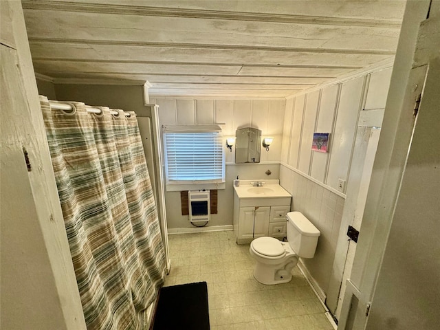 bathroom with heating unit, vanity, a shower with curtain, and toilet