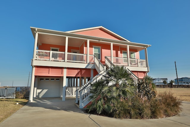 coastal home featuring a carport, a garage, and covered porch