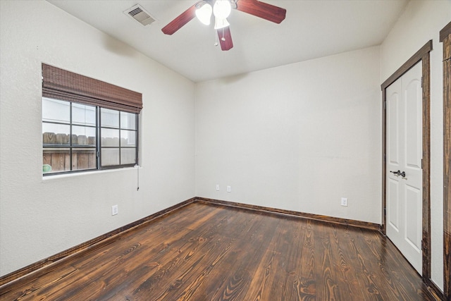 spare room featuring ceiling fan and dark hardwood / wood-style flooring