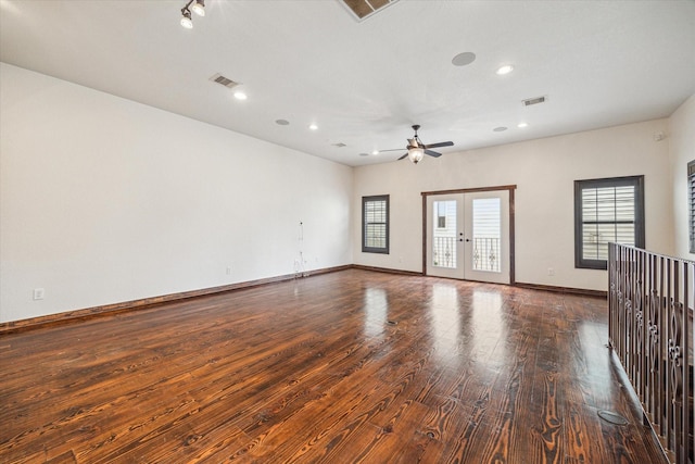 unfurnished room with dark hardwood / wood-style floors, ceiling fan, and french doors