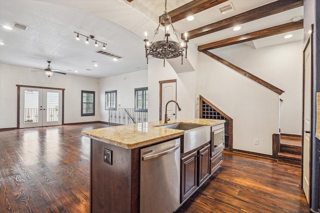 kitchen with french doors, sink, dark hardwood / wood-style flooring, stainless steel appliances, and a kitchen island with sink