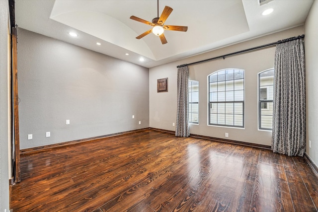 spare room with vaulted ceiling, dark wood-type flooring, and ceiling fan