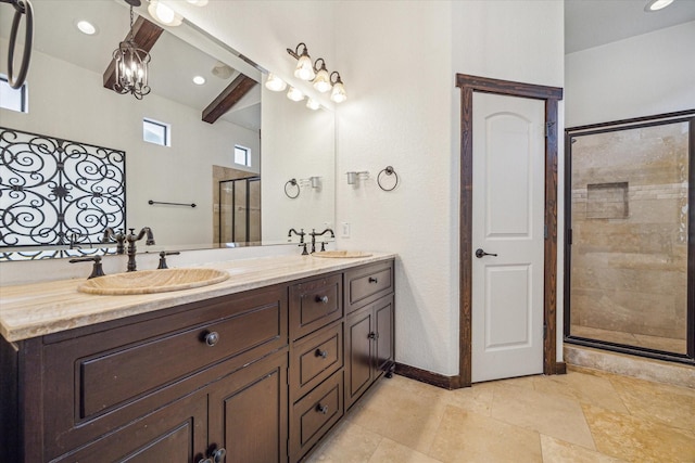 bathroom with beamed ceiling, vanity, and a shower with door